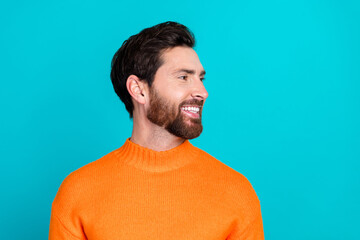 Sticker - Photo of cheerful handsome man wear orange trendy pullover look empty space isolated on cyan color background