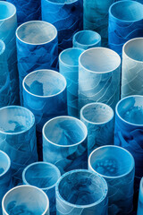 Aufkleber - Isometric abstract seamless pattern of blue and white cylindrical shapes arranged in a grid,