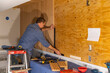 © Raymond Forbes LLC/Stocksy - Home Construction Carpenter with tool building Vertical wall