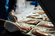 © Luis Herrera/Stocksy - Employe Packing fish fillets