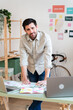 © nomad studio/Stocksy - Smiling Businessman at Creative Office