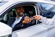 © Jovo Jovanovic/Stocksy - Handing off the car key to happy customer