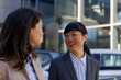 © Jovo Jovanovic/Stocksy - Two employees having a conversation outside the office