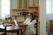 © Mihajlo Ckovric/Stocksy - Adult woman working from home using laptop for a video call