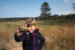 © Jelena Jojic Tomic/Stocksy - Portrait of a boy examining a mushroom