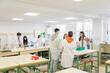 © Santi Nuñez/Stocksy - Engaged Learning in Laboratory with a teacher