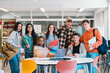 © Santi Nuñez/Stocksy - Multicultural Students Smiling in a library of university