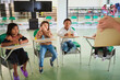 © J Esteban Berrío/Stocksy - Latino children participating in the classroom