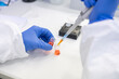 © Hernandez & Sorokina/Stocksy - Anonymous Researcher Working In Lab Using Pipette