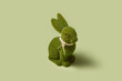 © Yaroslav Danylchenko/Stocksy - Easter bunny statuette with artificial grass fur on pastel background