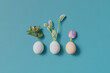 © Yaroslav Danylchenko/Stocksy - Stylish handmade set of three chicken eggs with blooming plants
