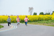 © Bo Bo/Stocksy - happy asian kids running in the spring day