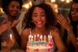 © YURIMA - A young woman celebrates her birthday with friends, sharing laughter, cutting cake, creating a cheerful atmosphere, spreading happiness and togetherness in a festive party setting
