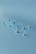 © Giada Canu/Stocksy - 3D Render of Wooden Nodes and Location Marker in Network Concept