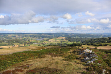 Wall Mural - Scenic landscape with rolling hills, green grass, and fluffy clouds in the sky. Wales