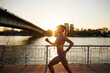 © Boris Jovanovic/Stocksy - Sportswoman running beneath the bridge