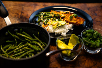 Wall Mural - a plate topped with cooked green beans and chicken with rice