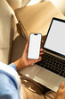 © Artem Podrez/Stocksy - Mockup phone with white screen and Unboxing parcels and working laptop