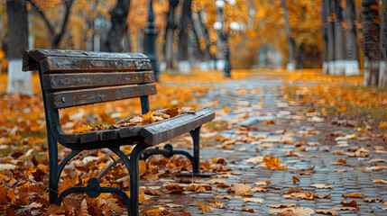 Wall Mural - A bench in an autumn park with a lot of torn orange maple leaves