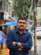 © Dream Lover/Stocksy - A middle aged Indian man standing on a street