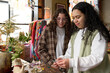 © Rowena Naylor/Stocksy - Young lesbian couple shopping together