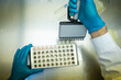 © Carlos Gonzales/Stocksy - Taking pipette samples at a lab