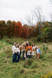 © Serena Burroughs/Stocksy - portrait of a big extended family outdoors in autumn