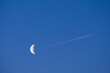 © Oleksandr Stalovierov/Stocksy - Moon and airplane on morning sky.