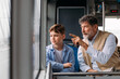© Studio Firma/Stocksy - Grandad and grandson riding bus