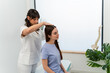 © nomad studio/Stocksy - Physical therapist conducting neck evaluation