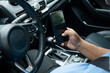 © Marc Tran/Stocksy - Businessman using mobile phone in the car