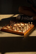 © Stephanie Tamir/Stocksy - A chess board on the floor with a golden light perking through.