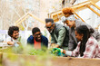 © BONNINSTUDIO/Stocksy - Group of volunteers working in community garden