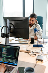 A man uses a computer in the office