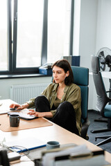 A woman uses a computer in the office