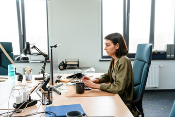A woman uses a computer in the office