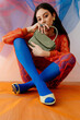 © Tania Cervian/Stocksy - Confident fashionable female model with handbag sitting on floor
