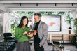 © VICTOR TORRES/Stocksy - Colleagues analyzing data on a tablet in the office