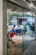© VICTOR TORRES/Stocksy - Team Meeting in Glass-Walled Office
