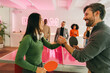 © VICTOR TORRES/Stocksy - Fun and competitive office table tennis match
