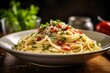 © KHF - Classic Italian pasta dish with spaghetti, pancetta, and fresh herbs.