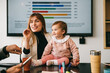 © VICTOR TORRES/Stocksy - Mother and Child in Business Meeting Environment