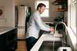 © Lea Jones/Stocksy - man doing dishes