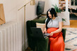 © Lea Jones/Stocksy - pregnant woman on laptop