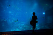 © Irina Polonina/Stocksy - Visitor Observes Aquarium Life Under Blue Light