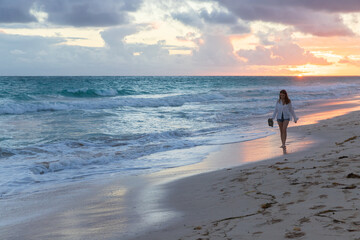 Wall Mural - Girl walks the beach in the sunrise