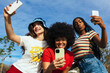 © BONNINSTUDIO/Stocksy - Happy diverse girlfriends taking selfie on smartphone