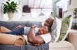 © peopleimages.com - Hug, black man and child lying on sofa with boy for relax, afternoon chill or comfort in living room. Family, embrace and single parent with kid for happiness, lazy weekend, bonding together in home