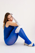 © Tania Cervian/Stocksy - Thoughtful woman sitting on floor with hand on head