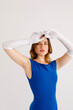 © Tania Cervian/Stocksy - Attractive woman standing in white long gloves